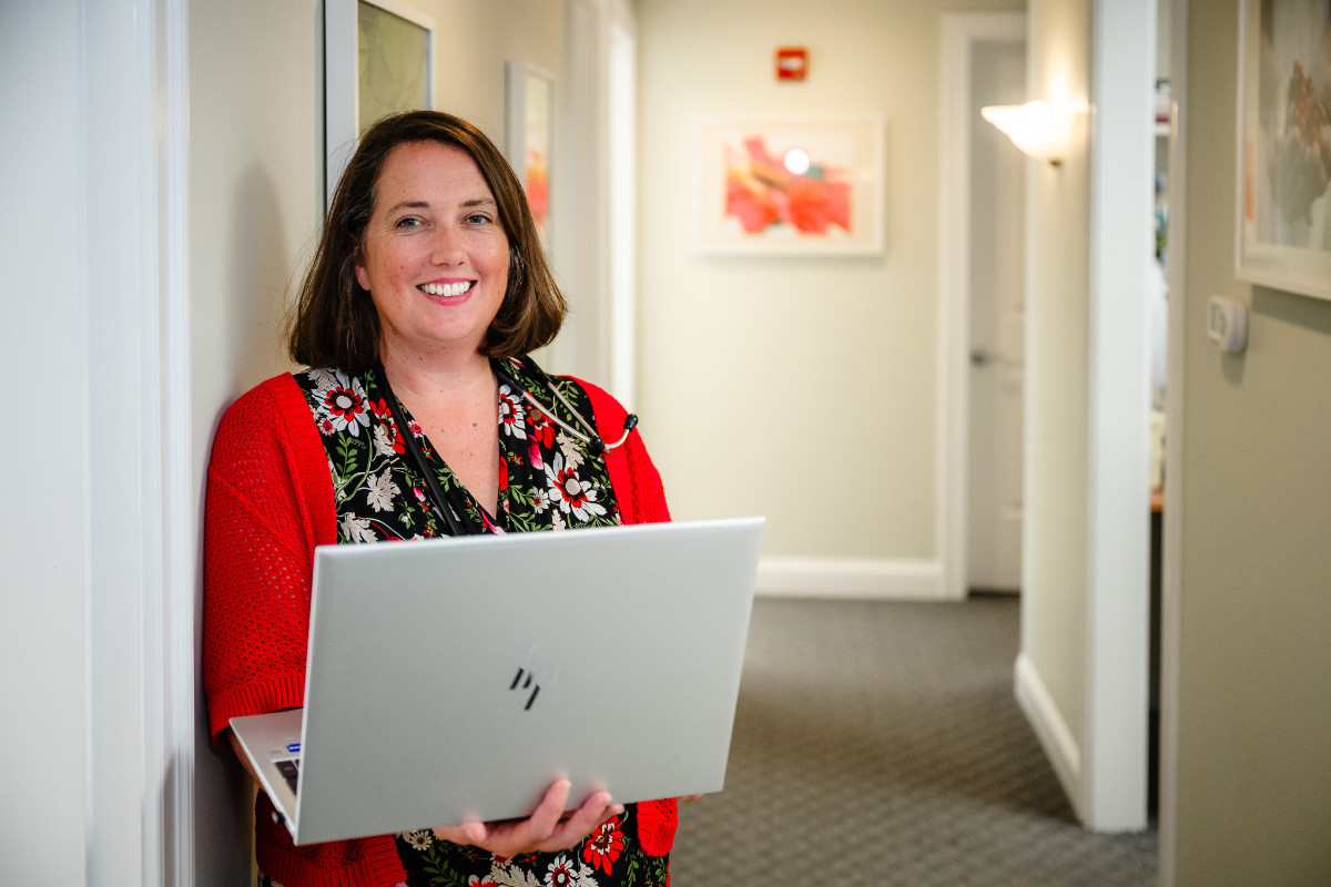 a woman holding a laptop